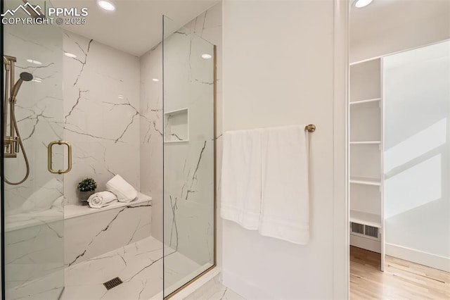 bathroom featuring wood-type flooring and walk in shower