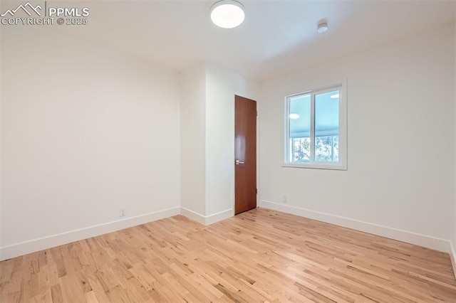 empty room with light hardwood / wood-style flooring