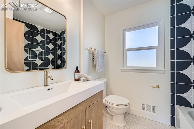 full bathroom with tile patterned floors, toilet, bathing tub / shower combination, and vanity