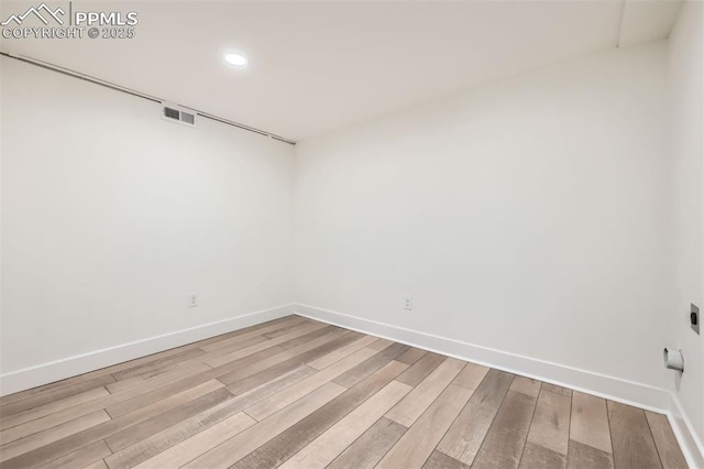 spare room featuring light hardwood / wood-style floors