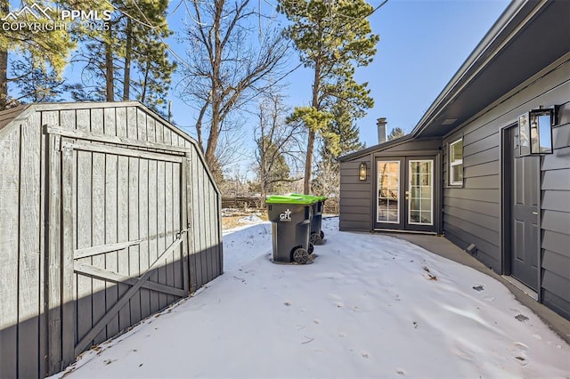 snow covered deck with a storage unit