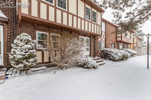 view of snow covered rear of property