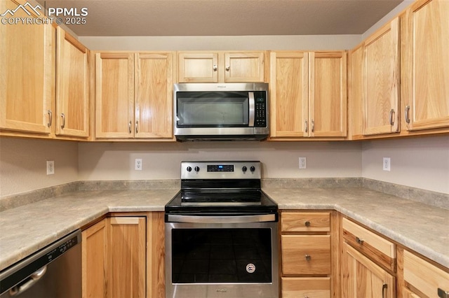 kitchen featuring appliances with stainless steel finishes and light brown cabinets