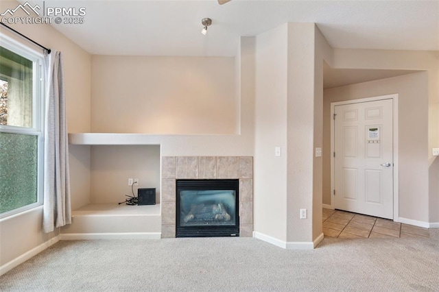 unfurnished living room with light carpet and a fireplace