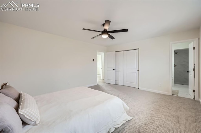 carpeted bedroom featuring a closet, ceiling fan, and ensuite bathroom