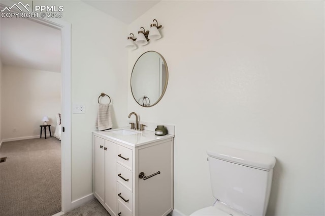 bathroom featuring vanity and toilet