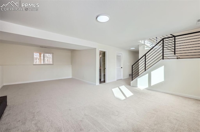 basement featuring light carpet