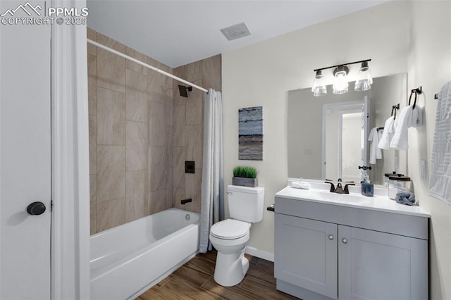 full bathroom with shower / tub combo, hardwood / wood-style floors, vanity, and toilet