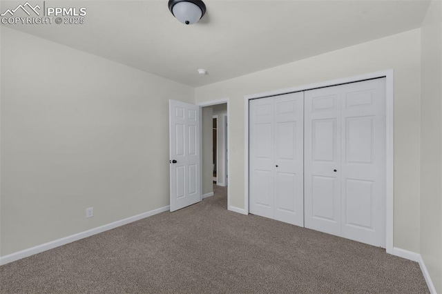 unfurnished bedroom featuring carpet floors and a closet