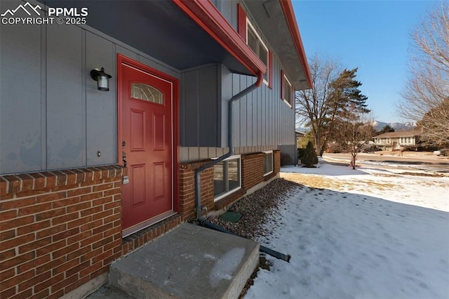 view of snow covered property entrance