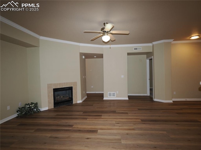 unfurnished living room featuring ceiling fan, ornamental molding, dark hardwood / wood-style floors, and a tile fireplace