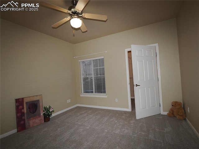 carpeted spare room featuring ceiling fan