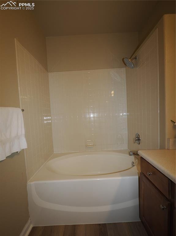 bathroom featuring vanity, tiled shower / bath combo, and hardwood / wood-style floors