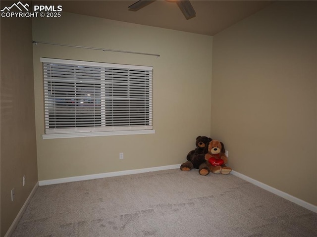 carpeted spare room featuring ceiling fan