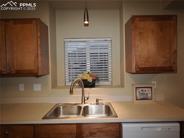 kitchen featuring hanging light fixtures, sink, and white dishwasher