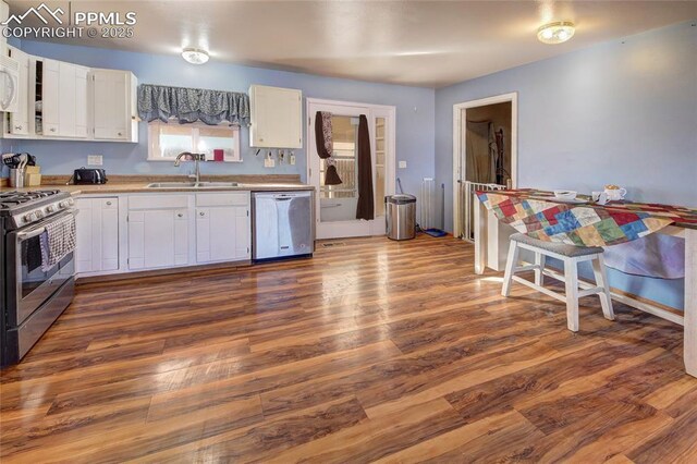 369 G St, Penrose, CO 81240 - kitchen with white cabinetry, appliances with stainless steel finishes, dark hardwood / wood-style floors, and sink