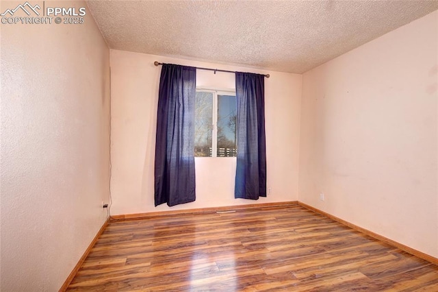 369 G St, Penrose, CO 81240 - empty room featuring hardwood / wood-style flooring and a textured ceiling