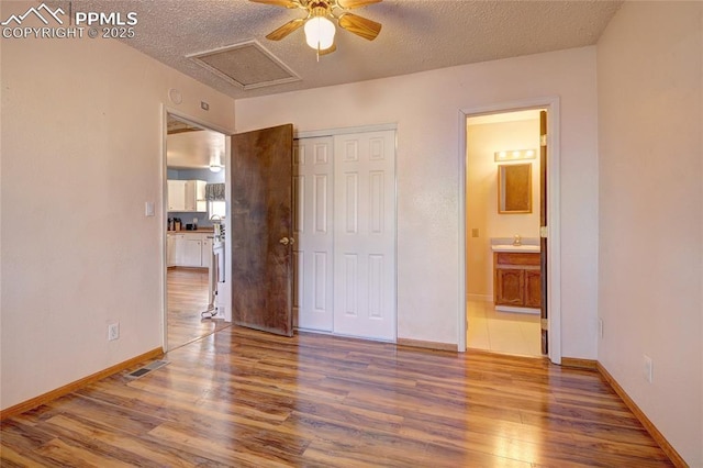 369 G St, Penrose, CO 81240 - unfurnished bedroom with hardwood / wood-style floors, a closet, and a textured ceiling