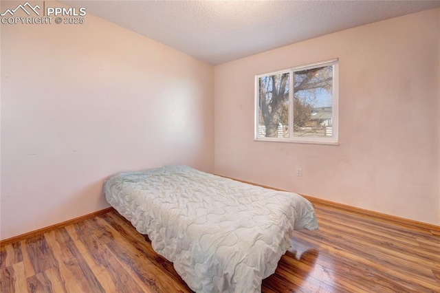 369 G St, Penrose, CO 81240 - bedroom featuring hardwood / wood-style flooring and a textured ceiling