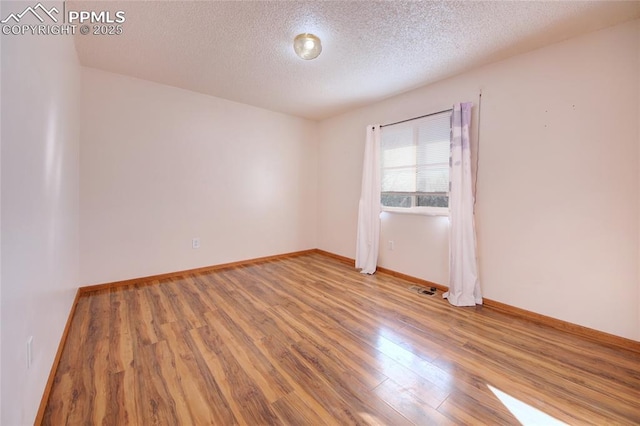 369 G St, Penrose, CO 81240 - empty room with wood-type flooring and a textured ceiling