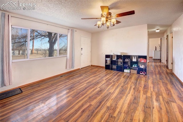 369 G St, Penrose, CO 81240 - spare room featuring ceiling fan, dark hardwood / wood-style flooring, and a textured ceiling