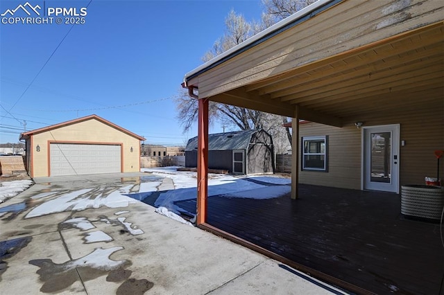 view of patio with a garage, central AC, and a storage unit