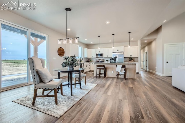 dining space featuring sink and wood-type flooring