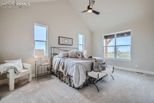 carpeted bedroom with ceiling fan, high vaulted ceiling, and multiple windows