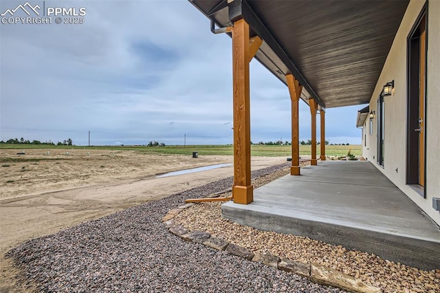 view of yard featuring a porch and a rural view