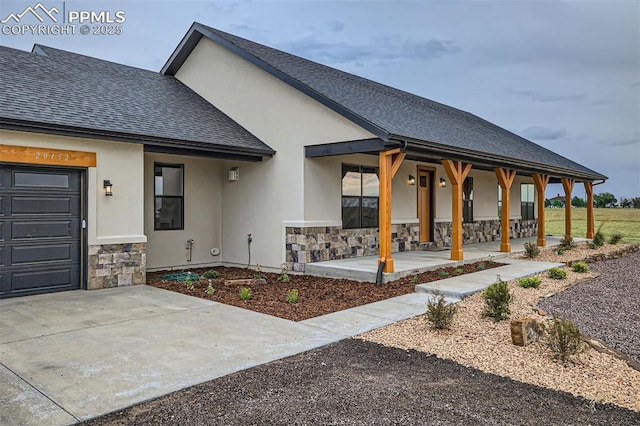 exterior space featuring a porch and a garage