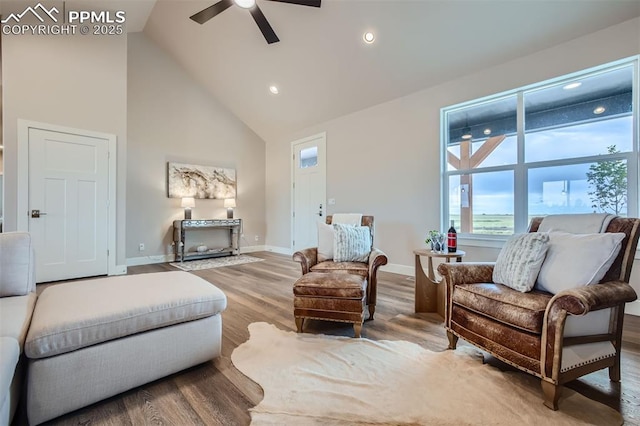 sitting room featuring ceiling fan, hardwood / wood-style floors, and high vaulted ceiling