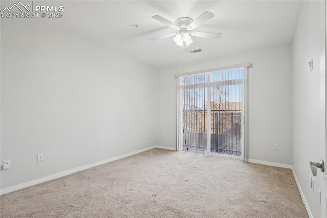 carpeted spare room with ceiling fan