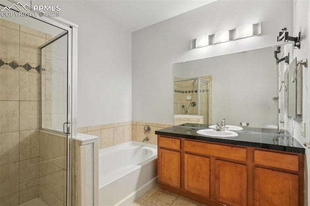 bathroom with vanity, tile patterned floors, and plus walk in shower