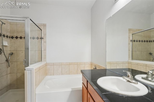 bathroom with vanity and separate shower and tub