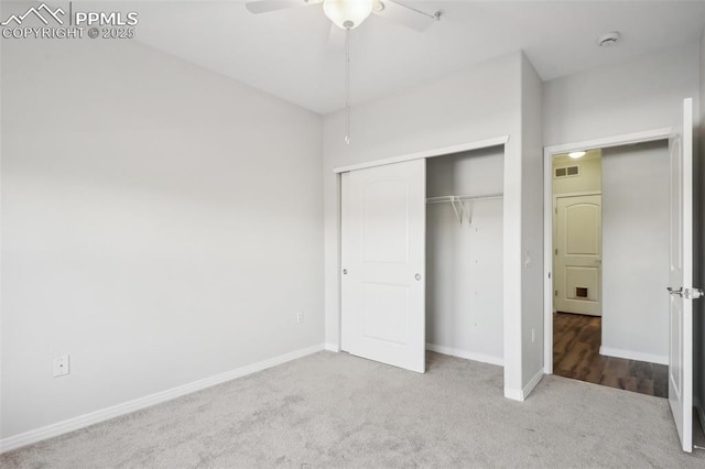 unfurnished bedroom featuring carpet flooring, ceiling fan, and a closet