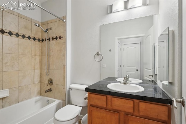 full bathroom with vanity, toilet, and tiled shower / bath combo