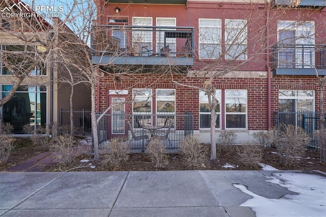 back of property with a balcony