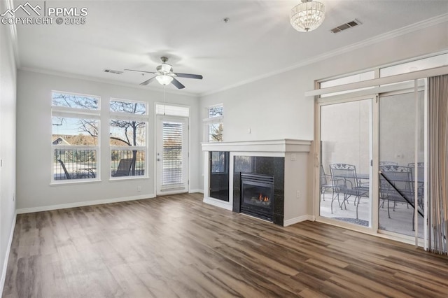 unfurnished living room featuring hardwood / wood-style floors, crown molding, a tile fireplace, and ceiling fan