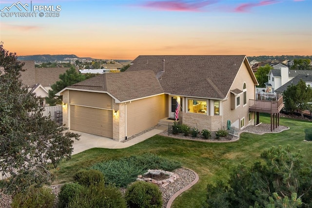 view of front of home with a garage and a yard