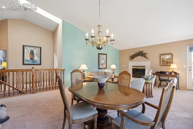 carpeted dining space featuring vaulted ceiling, a notable chandelier, and a fireplace