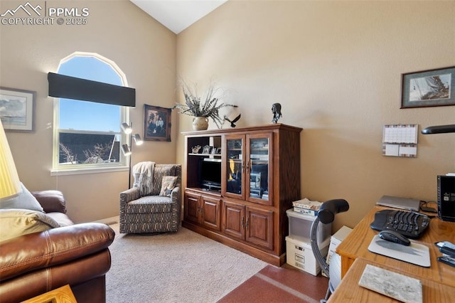 office area featuring lofted ceiling and dark colored carpet