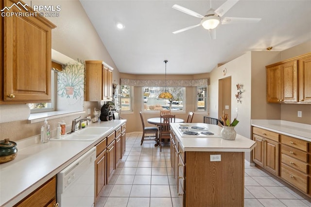 kitchen with sink, a center island, hanging light fixtures, white appliances, and a healthy amount of sunlight