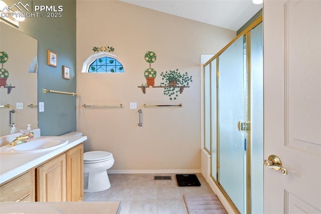 bathroom with an enclosed shower, vanity, tile patterned flooring, and toilet