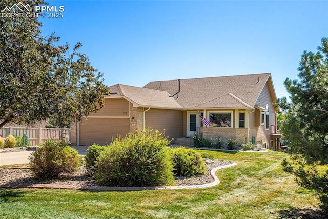 view of front of home with a garage and a front yard