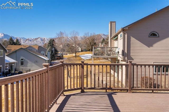 wooden deck with a mountain view