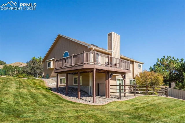 back of house with a yard and a deck