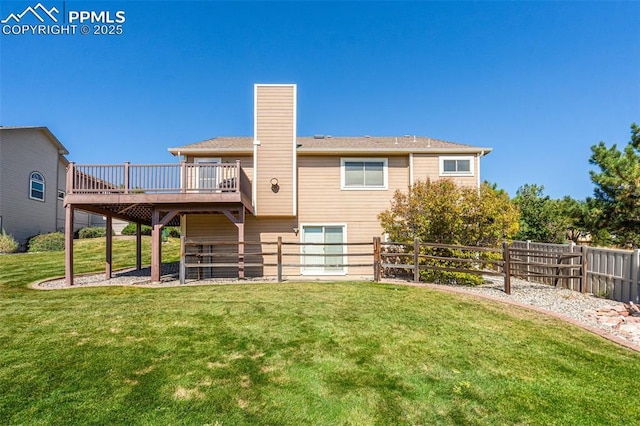 rear view of house featuring a wooden deck and a yard