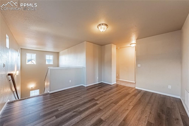 interior space with wood-type flooring and a textured ceiling