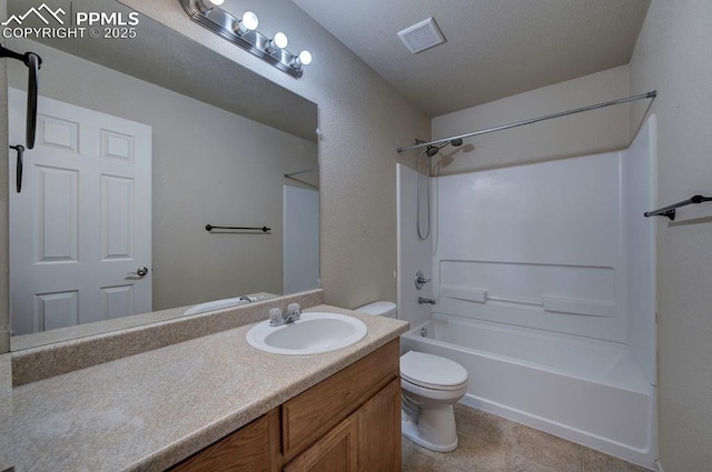 full bathroom with shower / bathing tub combination, tile patterned flooring, vanity, toilet, and a textured ceiling