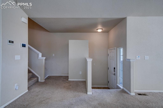 view of carpeted foyer entrance